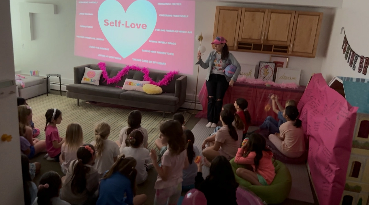 Florence leading a Neon Pink Self-Love session with a group of tween girls